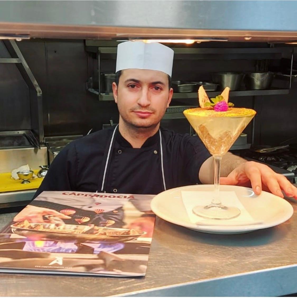 Chef Ridvan presenting a layered dessert