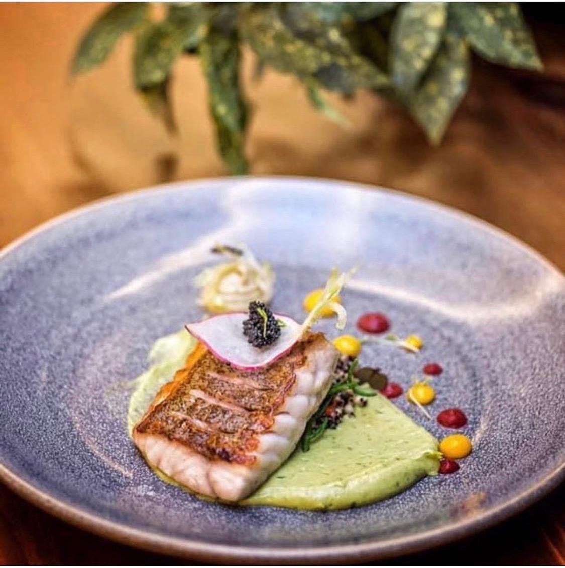 Pan-seared seabass with herb velouté, quinoa and caviar